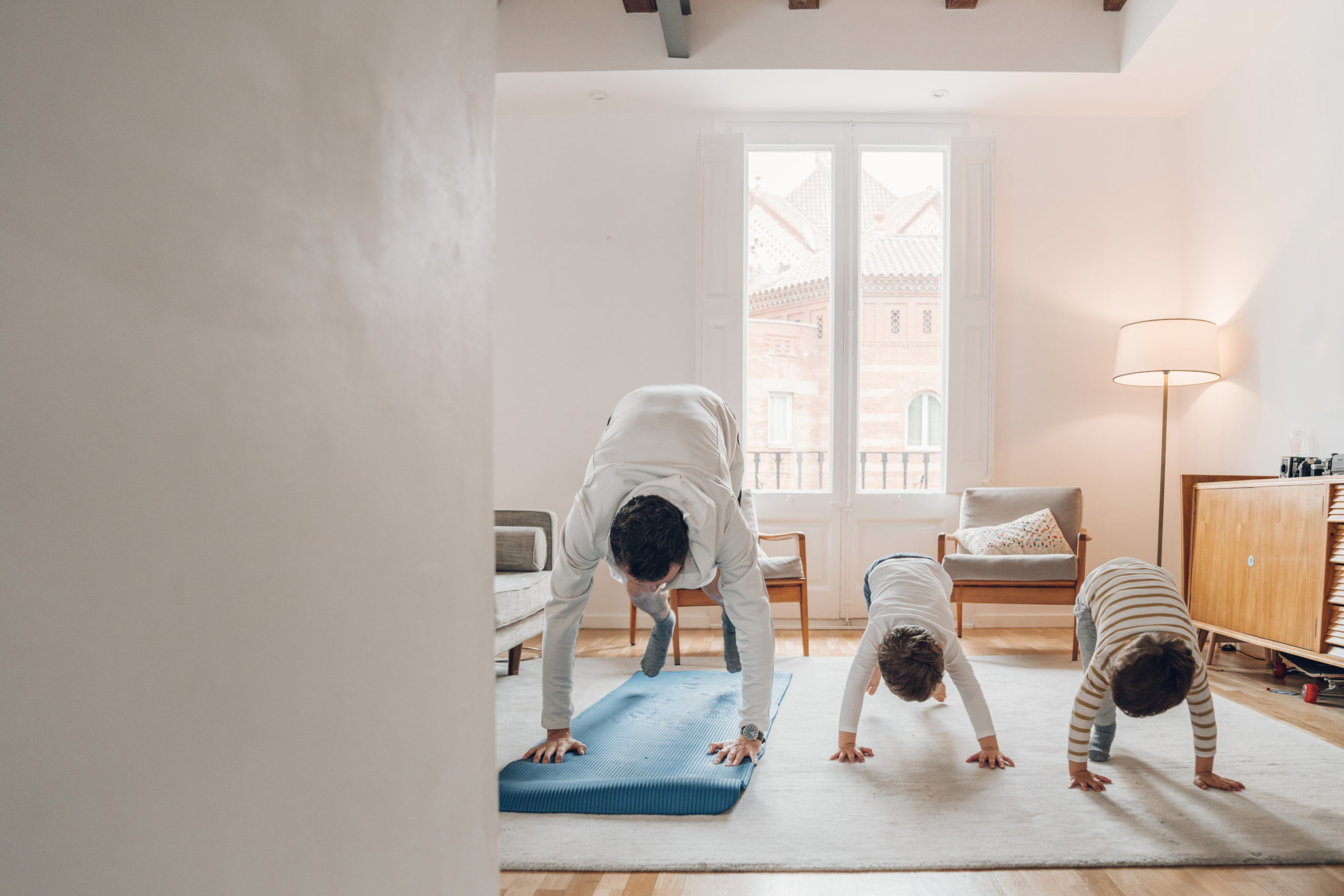 Father with children exercising at home