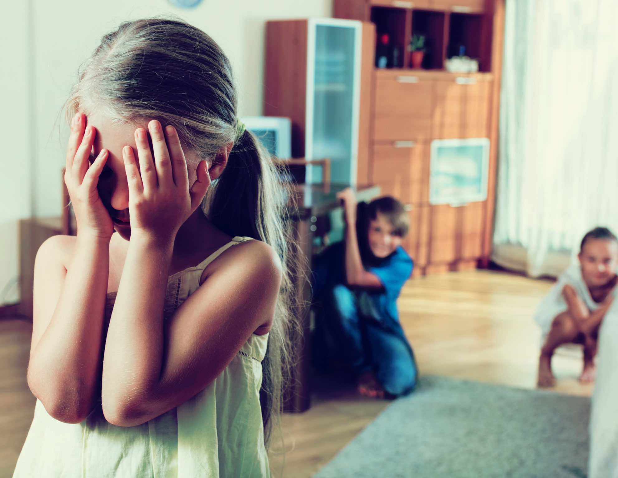 Joyful happy children hiding from girl